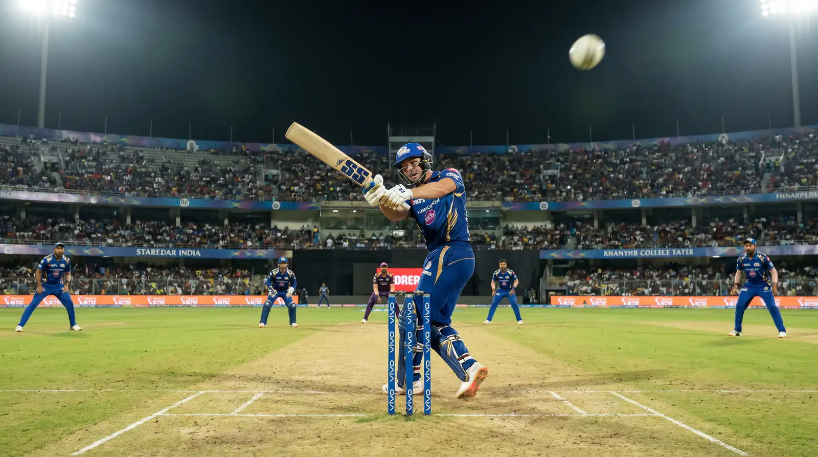 Cricket all-rounder striking the ball cleanly while batting