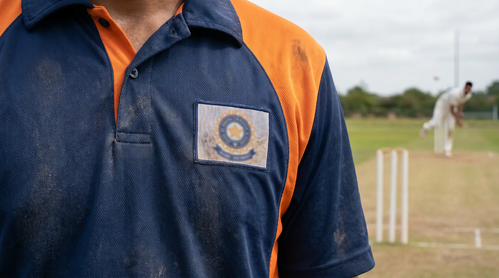 Close detail of a cricket shirt carrying a generic sponsor logo